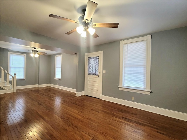 305 Macarthur St, Washington, MO 63090 - unfurnished room featuring dark wood-style flooring, a ceiling fan, stairs, and baseboards