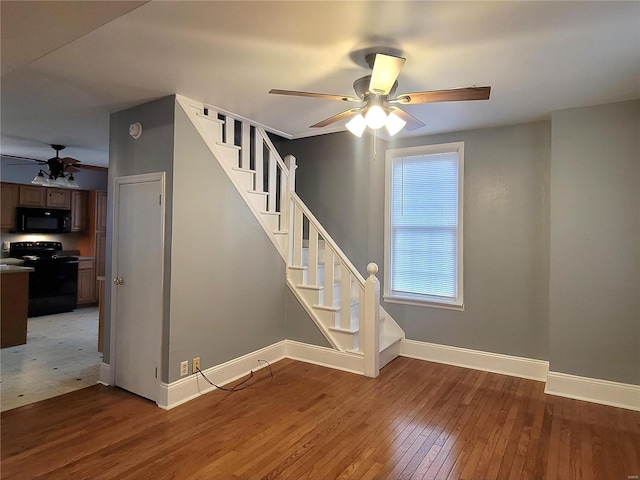 305 Macarthur St, Washington, MO 63090 - stairs with a ceiling fan, baseboards, and hardwood / wood-style flooring