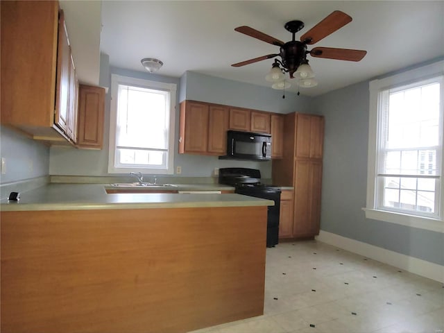 305 Macarthur St, Washington, MO 63090 - kitchen featuring black appliances, plenty of natural light, a sink, and a peninsula
