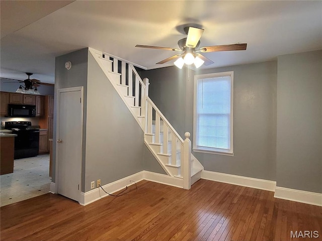 305 Macarthur St, Washington, MO 63090 - stairway with a ceiling fan and hardwood / wood-style flooring