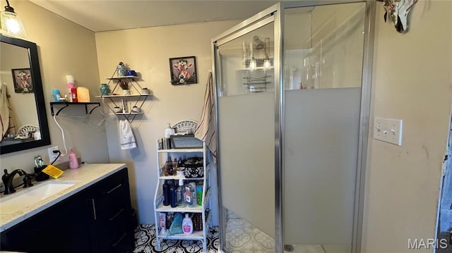 full bathroom featuring a stall shower and vanity