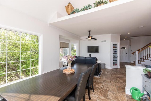 2314 Longest Dr, Wentzville, MO 63385 - dining space featuring healthy amount of natural light, stone finish floors, ceiling fan, stairs, and crown molding