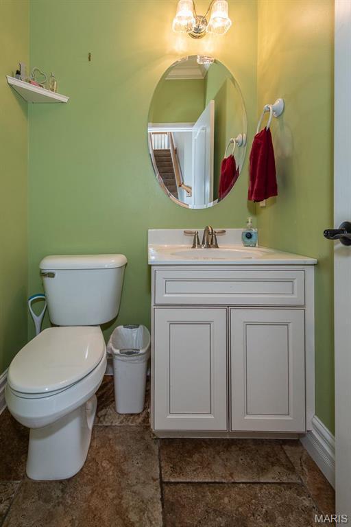 2314 Longest Dr, Wentzville, MO 63385 - bathroom featuring vanity, toilet, and baseboards