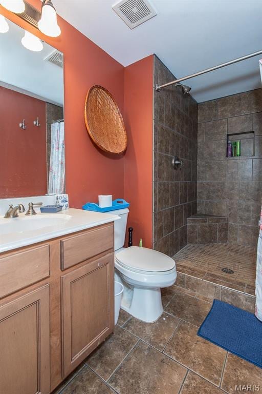 2314 Longest Dr, Wentzville, MO 63385 - bathroom with tiled shower, toilet, vanity, and tile patterned floors