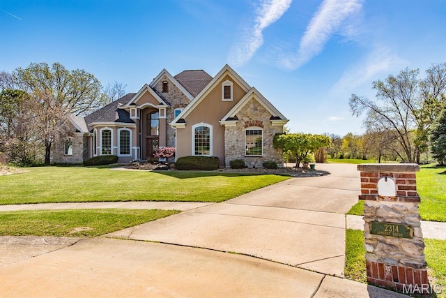 2314 Longest Dr, Wentzville, MO 63385 - traditional home featuring stone siding, a front lawn, and stucco siding