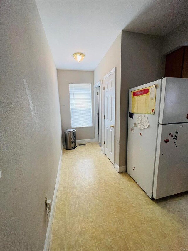 4934 W Florissant Ave, Saint Louis, MO 63115 - hallway with baseboards and light flooring