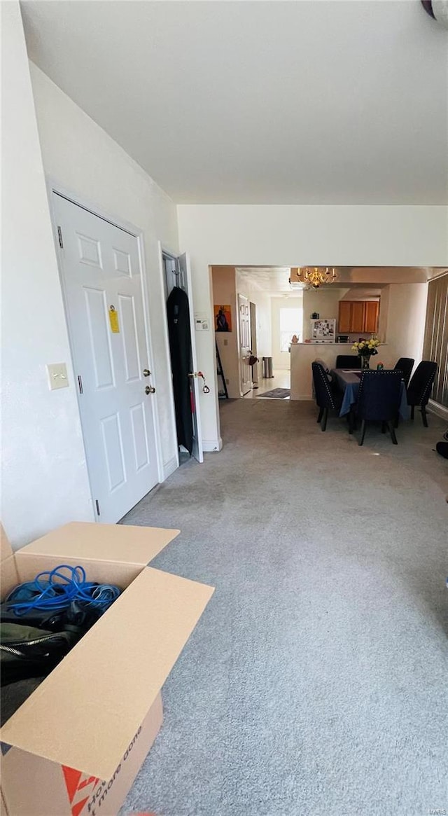 4926 W Florissant Ave, Saint Louis, MO 63115 - living area with light carpet and a chandelier