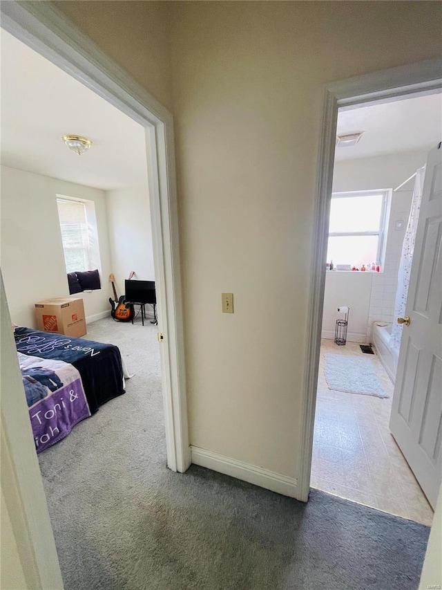 4926 W Florissant Ave, Saint Louis, MO 63115 - hallway with carpet floors and baseboards