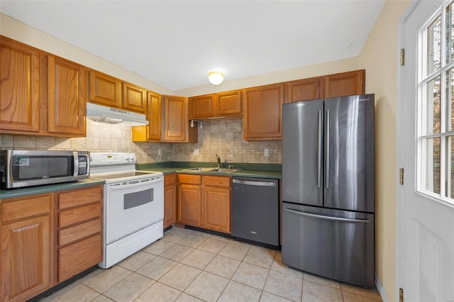 1443 Alberta Dr, Saint Charles, MO 63303 - kitchen with stainless steel appliances, under cabinet range hood, a sink, decorative backsplash, and light tile patterned floors