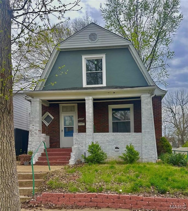 6522 Crest Ave, Saint Louis, MO 63130 - view of front of home featuring a porch, a gambrel roof, and brick siding