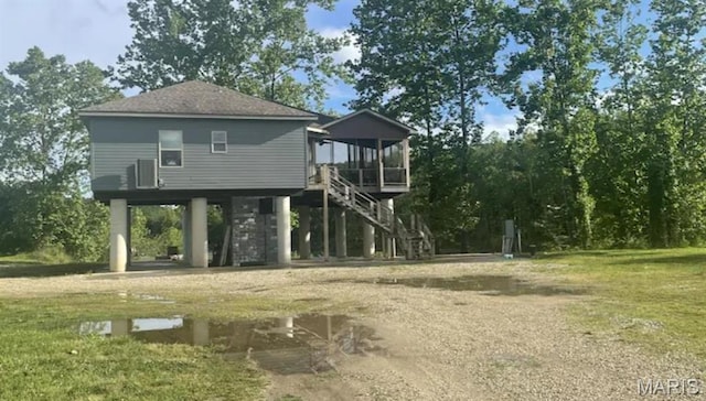 2358 Brown Rd, Van Buren, MO 63965 - back of property featuring stairway, a carport, a sunroom, and a lawn