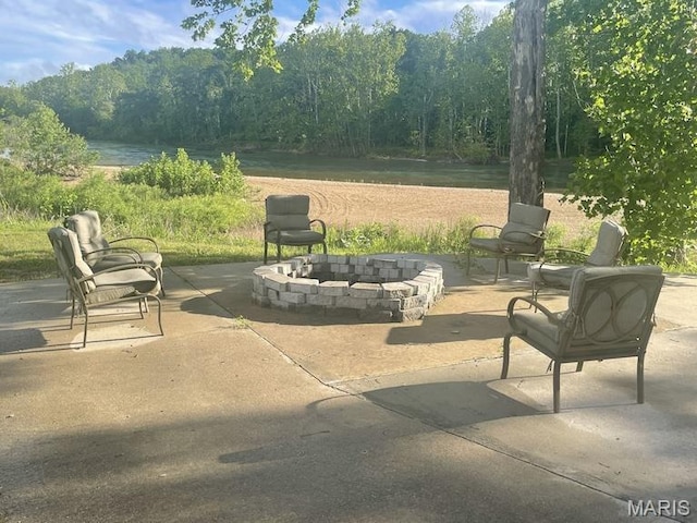 2358 Brown Rd, Van Buren, MO 63965 - view of patio featuring a fire pit, a view of trees, and a water view