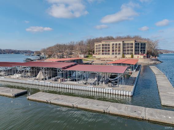 surrounding community featuring a water view and a dock