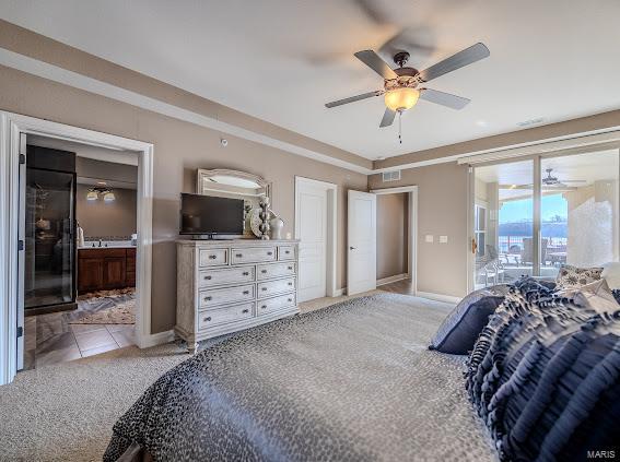 bedroom featuring access to exterior, light carpet, ensuite bathroom, baseboards, and ceiling fan