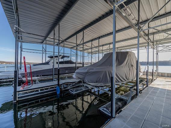 dock featuring boat lift and a water view