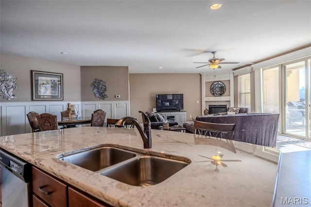 3168 Twin Rivers Pt, Camdenton, MO 65420 - kitchen featuring a sink, ceiling fan, light stone counters, and dishwasher