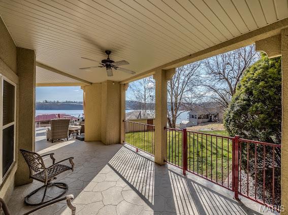 3168 Twin Rivers Pt, Camdenton, MO 65420 - view of patio / terrace with a water view and a ceiling fan