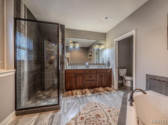 3168 Twin Rivers Pt, Camdenton, MO 65420 - bathroom with toilet, a stall shower, double vanity, a bath, and baseboards