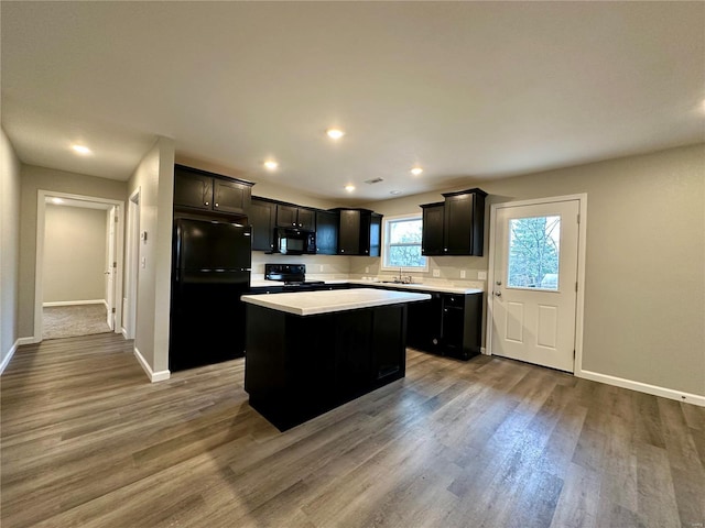 16 N Herren Ave, Ellsinore, MO 63937 - kitchen featuring black appliances, a sink, light countertops, dark wood-style flooring, and recessed lighting
