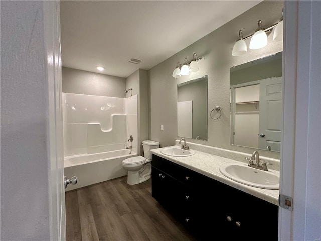 16 N Herren Ave, Ellsinore, MO 63937 - full bath with wood finished floors, toilet, tub / shower combination, and double vanity