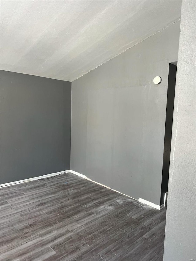 4610 Lexington Ave, Saint Louis, MO 63115 - empty room featuring lofted ceiling, dark wood finished floors, and baseboards
