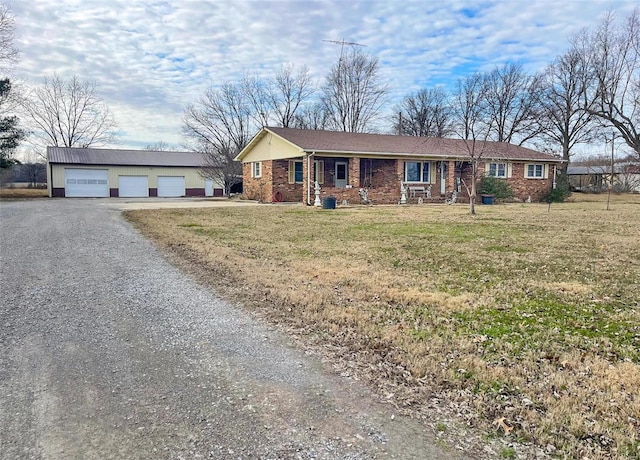 9667 State Highway 25 S, Dexter, MO 63841 - ranch-style house with a detached garage, an outdoor structure, a front yard, covered porch, and brick siding
