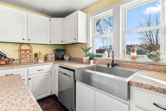 10751 State Route F, Farmington, MO 63640 - kitchen with stainless steel dishwasher, a sink, white cabinetry, light countertops, and dark tile patterned floors