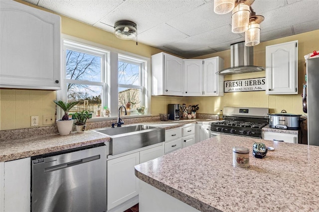 10751 State Route F, Farmington, MO 63640 - kitchen featuring appliances with stainless steel finishes, wall chimney range hood, a sink, white cabinets, and a drop ceiling