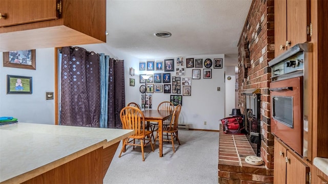 989 Clay St, Saint Clair, MO 63077 - dining room with a textured ceiling, carpet, and a fireplace