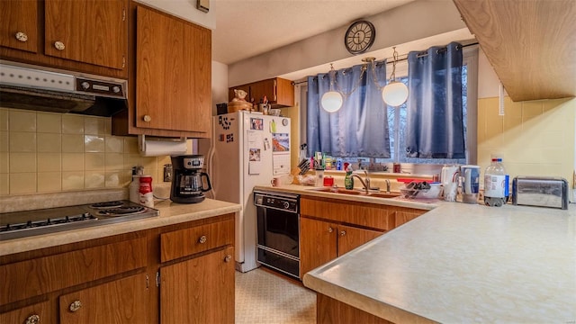 989 Clay St, Saint Clair, MO 63077 - kitchen with stainless steel electric stovetop, under cabinet range hood, brown cabinets, and decorative backsplash