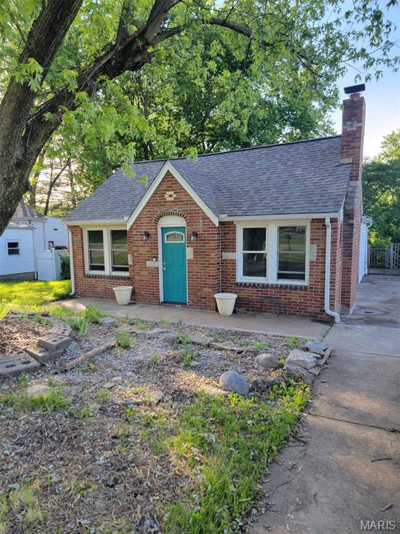 3305 Fee Fee Rd, Bridgeton, MO 63044 - view of front of property featuring brick siding, a shingled roof, and a chimney