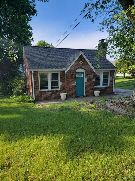 3305 Fee Fee Rd, Bridgeton, MO 63044 - english style home with a chimney, brick siding, a front lawn, and a shingled roof