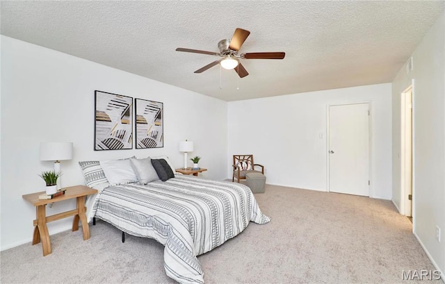 bedroom featuring carpet floors, ceiling fan, and a textured ceiling