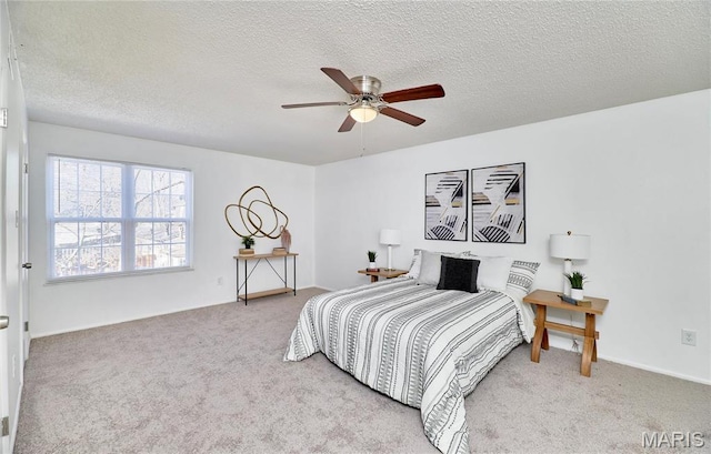 bedroom featuring carpet floors, a textured ceiling, and ceiling fan