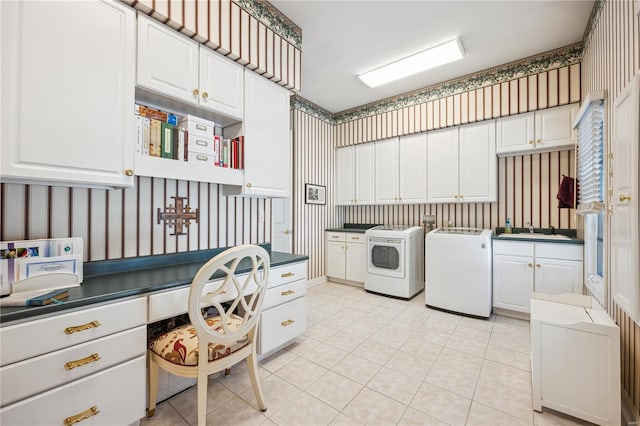 clothes washing area featuring washer and dryer, cabinet space, wallpapered walls, and light tile patterned flooring
