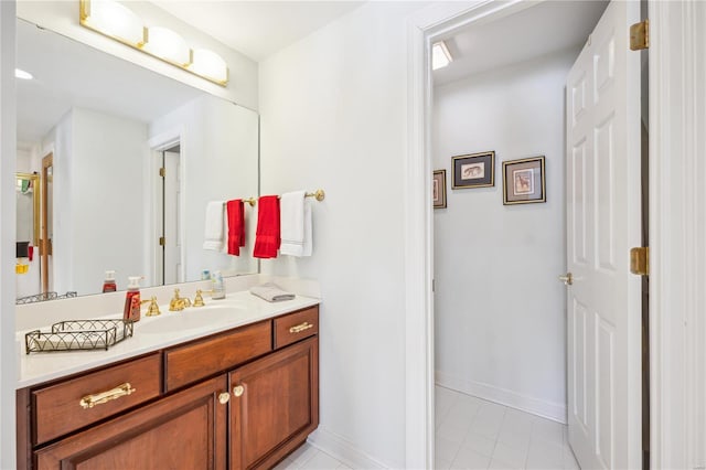 bathroom featuring tile patterned flooring, vanity, and baseboards