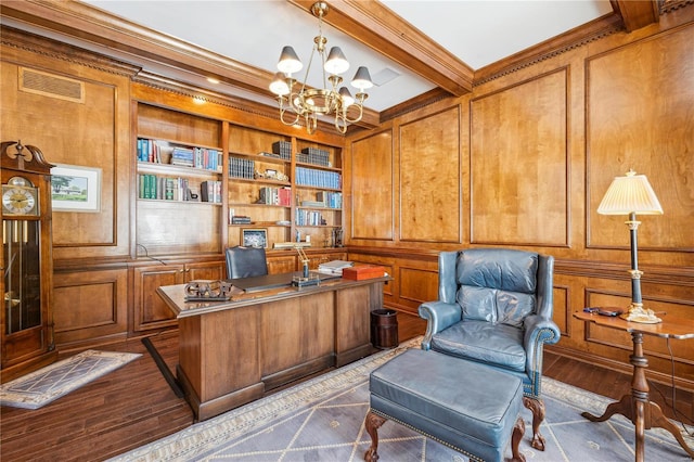 home office with a chandelier, built in shelves, wood walls, ornamental molding, and beam ceiling