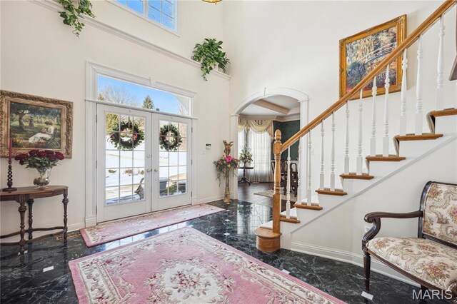19385 Deer Pointe Estates Dr, Wildwood, MO 63038 - foyer featuring a high ceiling, arched walkways, marble tiled floors, plenty of natural light, and baseboards