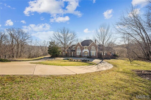 19385 Deer Pointe Estates Dr, Wildwood, MO 63038 - colonial inspired home with a chimney, stone siding, and a front yard