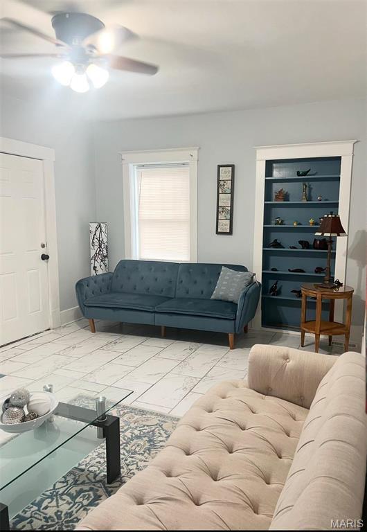 3511 Oakdale Ave, Saint Louis, MO 63121 - living area featuring light marble finish flooring, ceiling fan, and baseboards