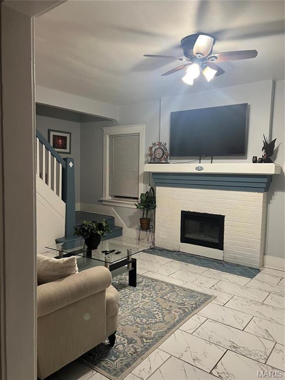 3511 Oakdale Ave, Saint Louis, MO 63121 - living room with marble finish floors, a ceiling fan, a brick fireplace, and baseboards