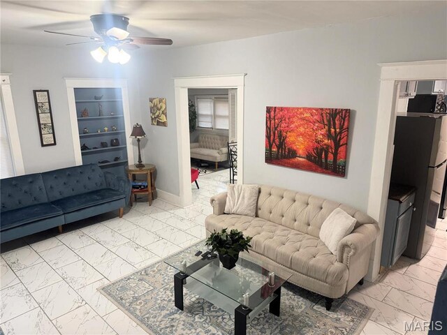 3511 Oakdale Ave, Saint Louis, MO 63121 - living area featuring light marble finish floors and ceiling fan