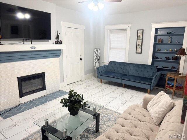 3511 Oakdale Ave, Saint Louis, MO 63121 - living area featuring marble look tile flooring, ceiling fan, and baseboards