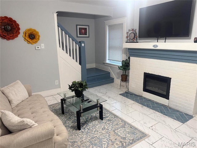 3511 Oakdale Ave, Saint Louis, MO 63121 - living room with marble finish flooring, stairs, a brick fireplace, and baseboards