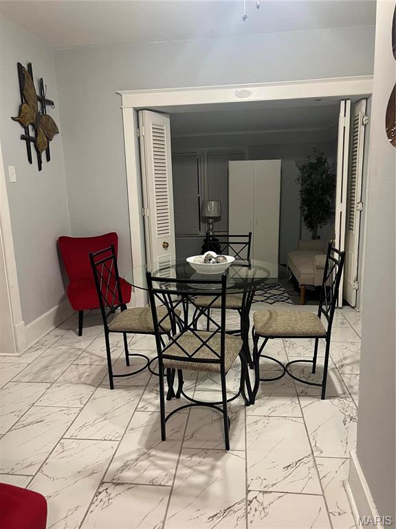 3511 Oakdale Ave, Saint Louis, MO 63121 - dining space featuring light marble finish floors and baseboards