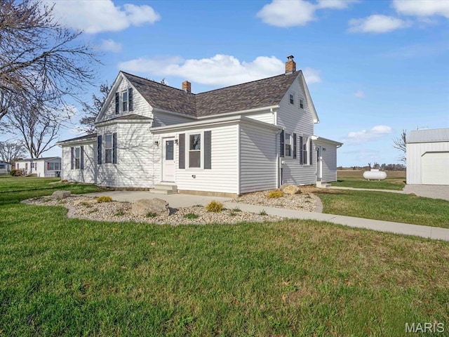 view of property exterior featuring entry steps, a lawn, and a chimney