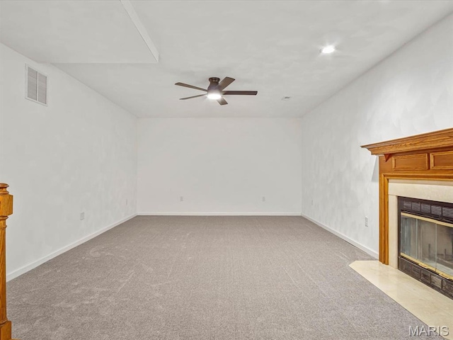 unfurnished living room with a fireplace with flush hearth, carpet flooring, ceiling fan, and baseboards