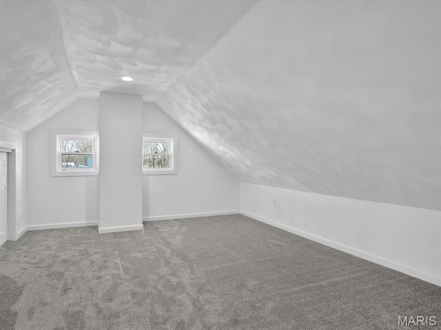 bonus room featuring vaulted ceiling, carpet, and baseboards