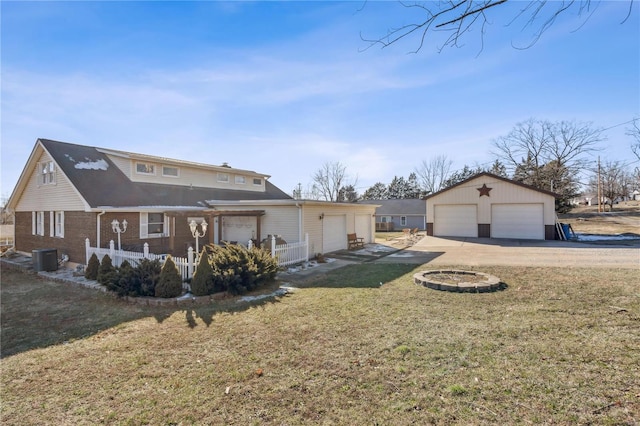 219 Cypress St, Park Hills, MO 63601 - rear view of house featuring a yard, a garage, cooling unit, an outbuilding, and brick siding