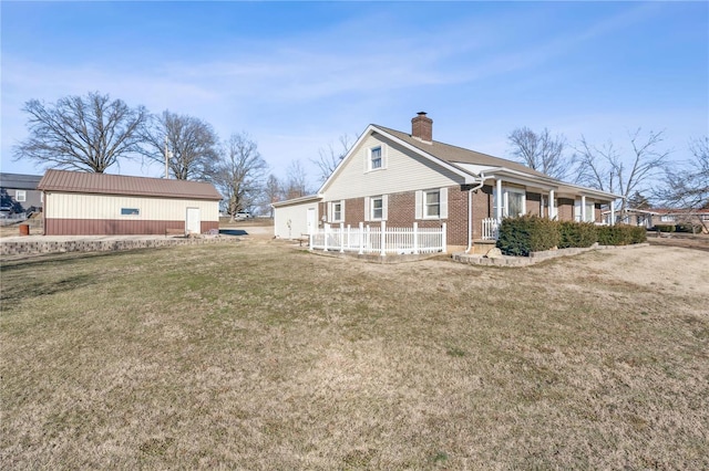 219 Cypress St, Park Hills, MO 63601 - view of side of home featuring a chimney, brick siding, covered porch, and a lawn